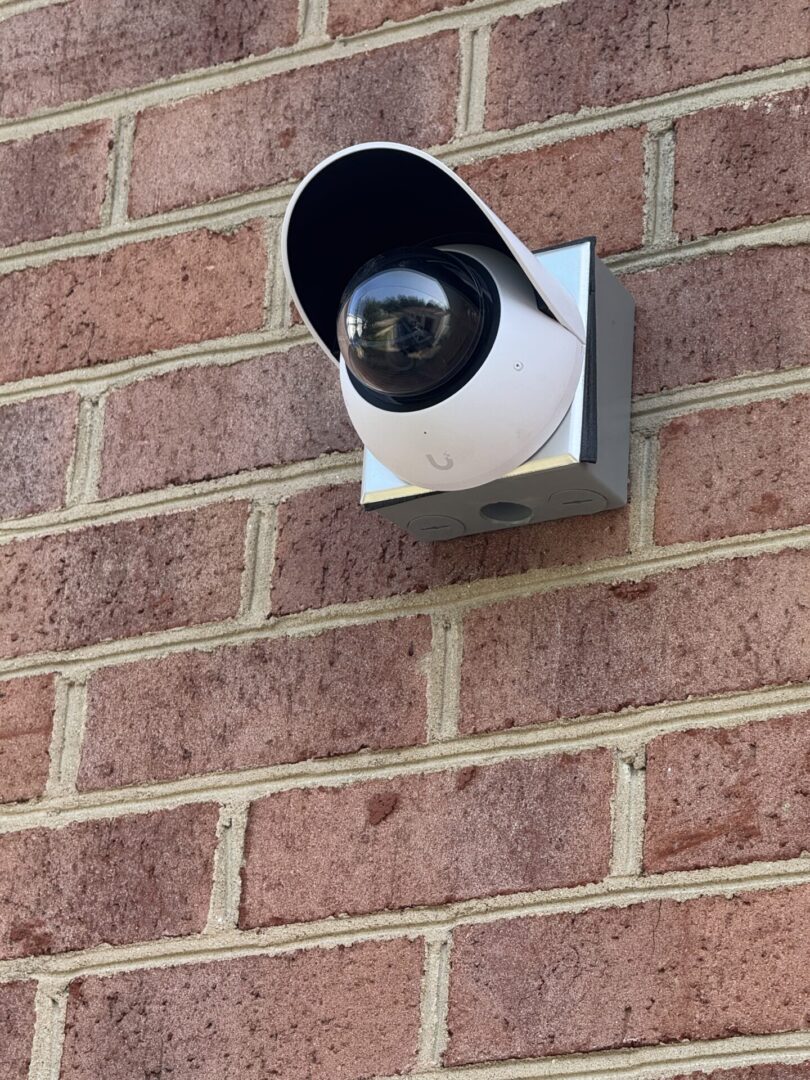 UniFi security camera on brick