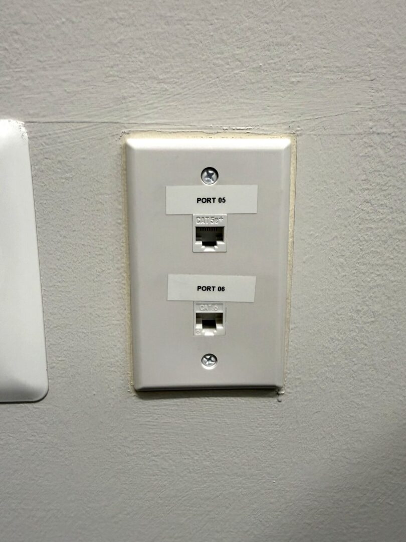 Secur3iT installed and labeled CAT6 structured cabling wall plate in commercial office